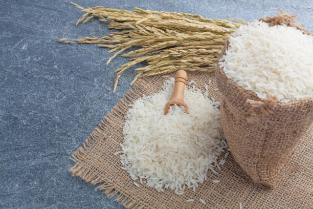 istock thai fragrant jasmine rice in a spoon with gold spike on Sack 689663284