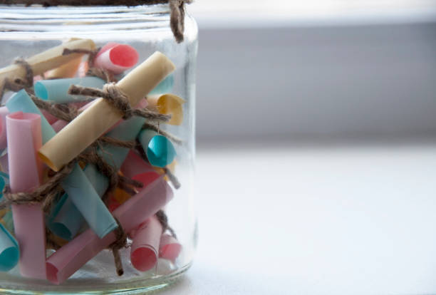 istock Glass jar with colored notes with blur and toning 689666932
