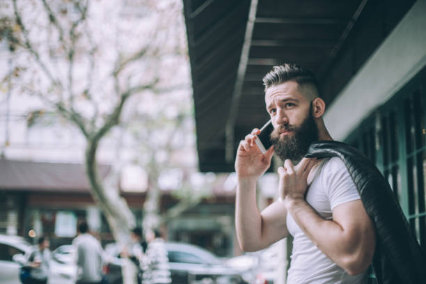 istock Hipster man talking on mobile phone 689677258
