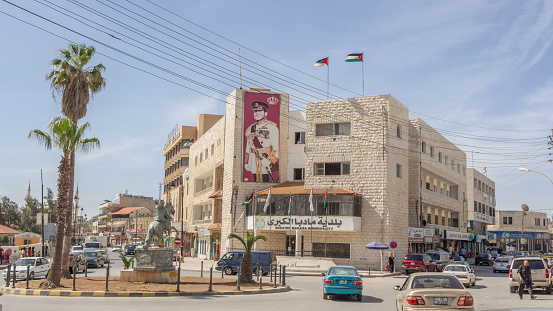 Centre of Madaba in Jordan with the municipality building of Madaba and a banner with king Abdullah