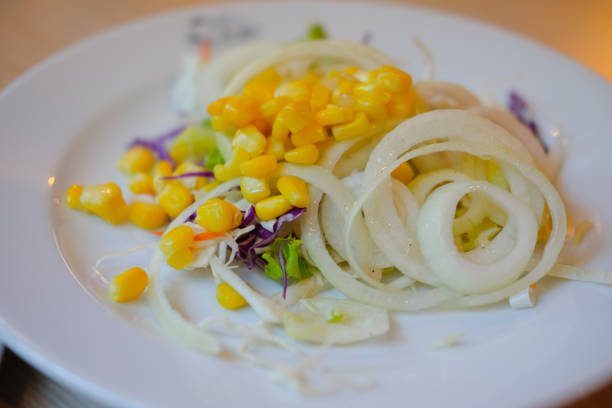 istock vegetable salad with corn and onion on white dish 689681728