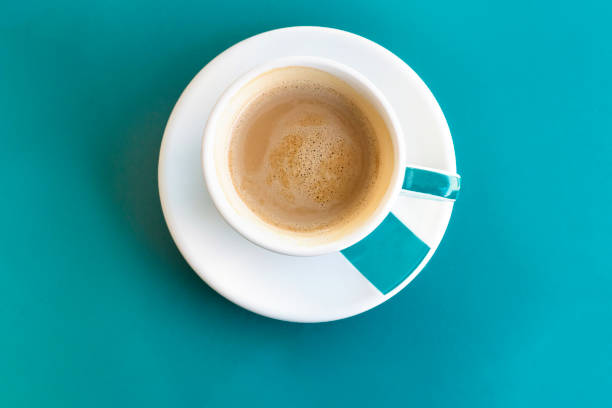 istock Cup of coffee on turquoise with copyspace 689684668