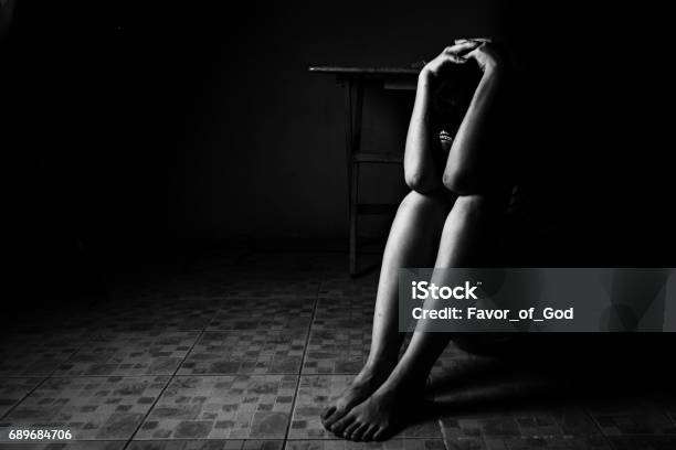A Woman Sitting On Ground With Arm Around Lower Head Sexual Violence Sexual Abuse Human Trafficking Concept Stock Photo - Download Image Now