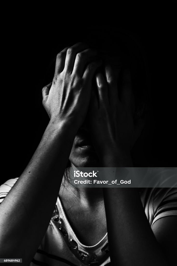 depress woman standing in the dark in white tone Women Stock Photo