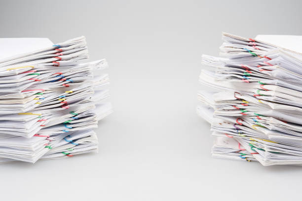 istock Dual pile overload of document with colorful paper clip 689698502