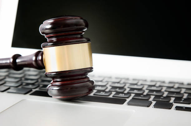 istock Wooden gavel on laptop keyboard 689705338