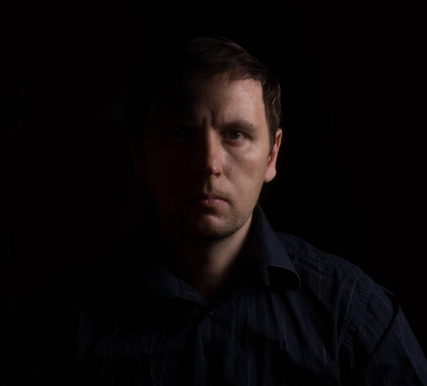 istock Dramatic portrait of a man in a low key. People 689705404