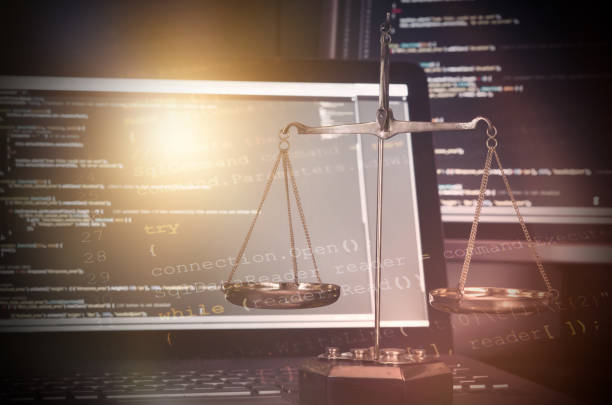istock Justice weight scales with code on monitor in background 689705948