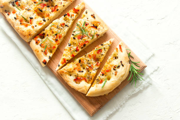 Italian Focaccia Traditional Italian Focaccia with tomatoes, black olives and rosemary - homemade flat bread focaccia flatbread stock pictures, royalty-free photos & images