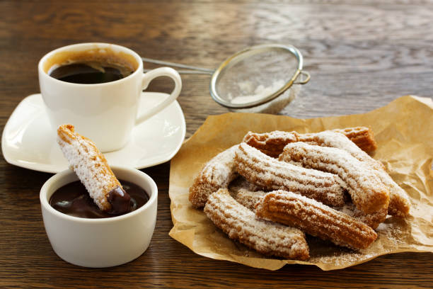 istock Churros with hot chocolate and powdered sugar. 689707462