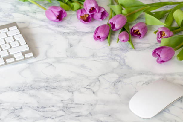 istock Woman office desk with blossom flowers 689713432
