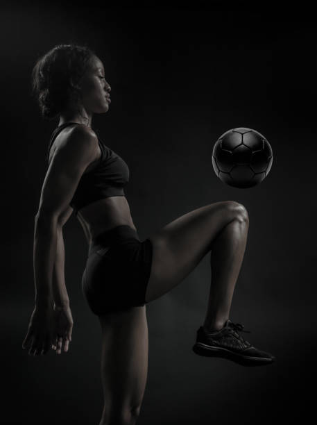 istock Female Soccer Player Kneeing The Ball 689719754