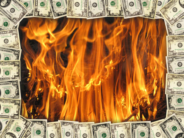 istock frame from the dollars on the background of flame 689725618