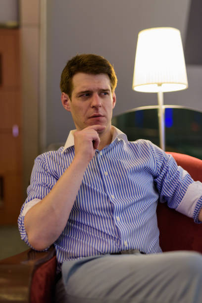istock Portrait of man sitting indoors 689728306