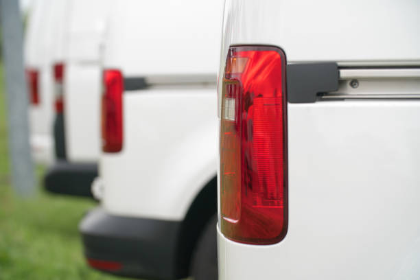 istock White Vans / Transporter with focus on the rear light 689728940