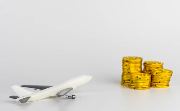 istock Saving gold money for air plane ticket vacation travel 689731404