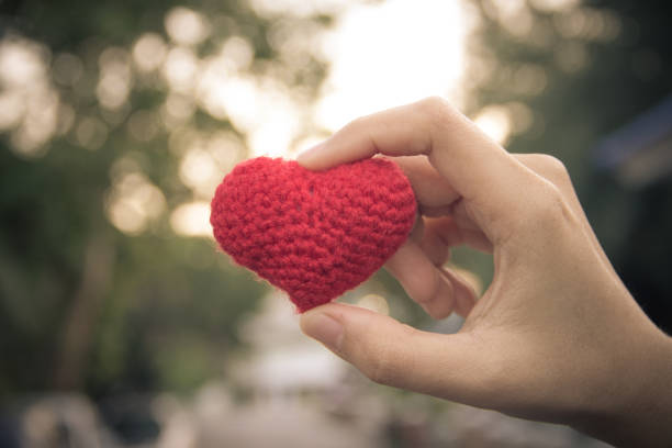 istock Hand holding red heart on bokeh blurred background,valentine day concept 689735012