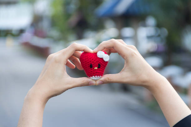 istock Finger made heart symbol blurred background 689735070