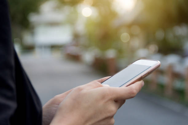 istock Woman hold phone with blurred bokeh background 689735136