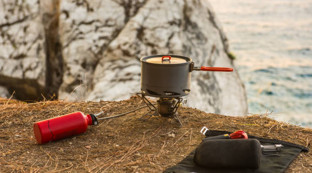 Tourist equipment and tools: camping gas Tourist equipment and tools: camping gas over sea background camping stove photos stock pictures, royalty-free photos & images