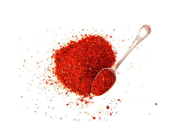 istock Red chili pepper powder on white background 689750054