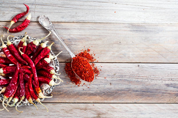 istock Dried red chili pepper on wooden background 689750076