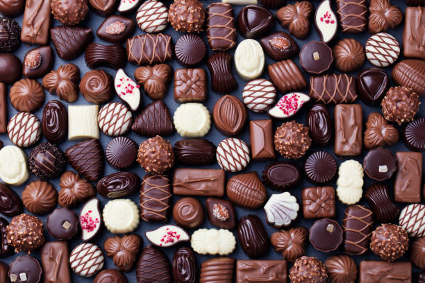 Assortment of fine chocolate candies. Top view Assortment of fine chocolate candies, white, dark, and milk chocolate Sweets background Copy space Top view chocolate stock pictures, royalty-free photos & images