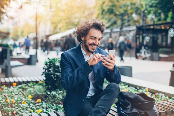 istock Small business owner texting on the street 689759274