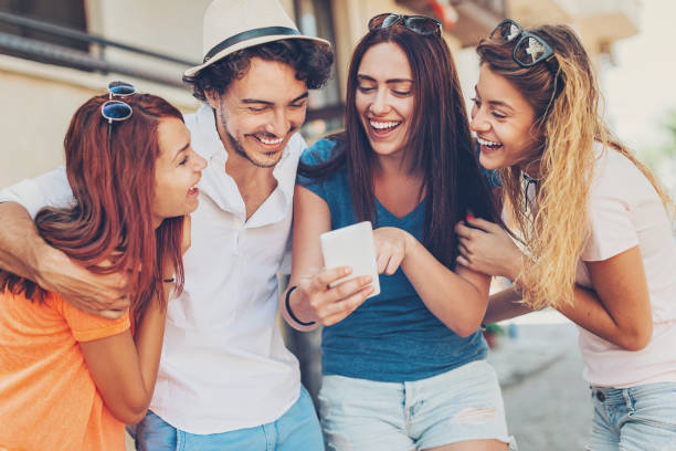 istock Beautiful young people looking at smart phone 689759288