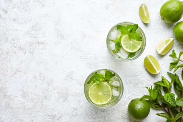 Mojito cocktail alcohol bar long drink traditional fresh tropical beverage top view copy space two highball glass stock photo