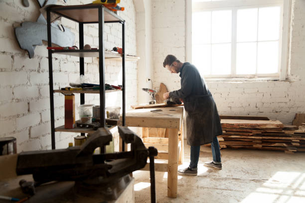 istock Skilled self-employed carpenter working with wood in carpentry workshop interior 689766020