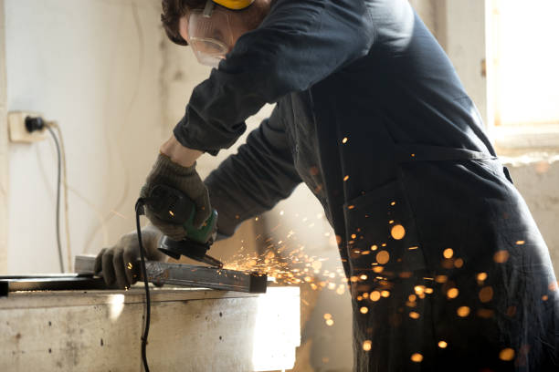 istock Skilled workman grinding metal profile pipe with lot of sparks 689766114