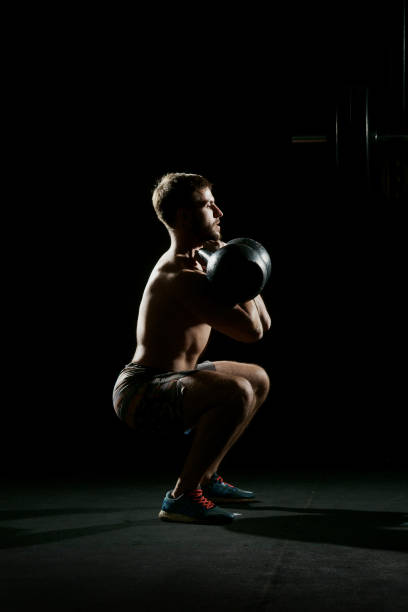 istock Fitness training. Man doing sit ups with weights 689771138