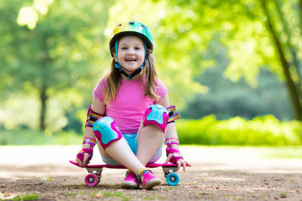 istock Child riding skateboard in summer park 689777772
