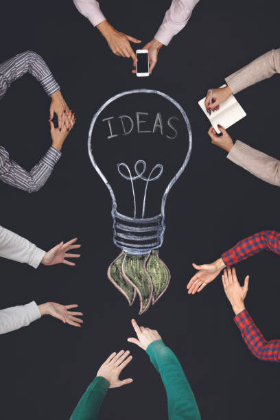 istock Teamwork concept - top view of six people work on a blackboard. 689781240