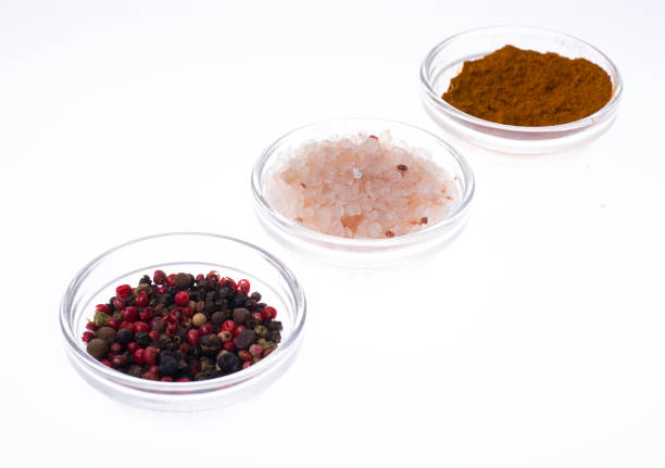Salt, black pepper and curry in glass isolated on white backgrou