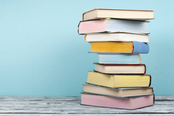 Open book, stacking, hardback books on wooden table and background. Back to school. Copy space for text