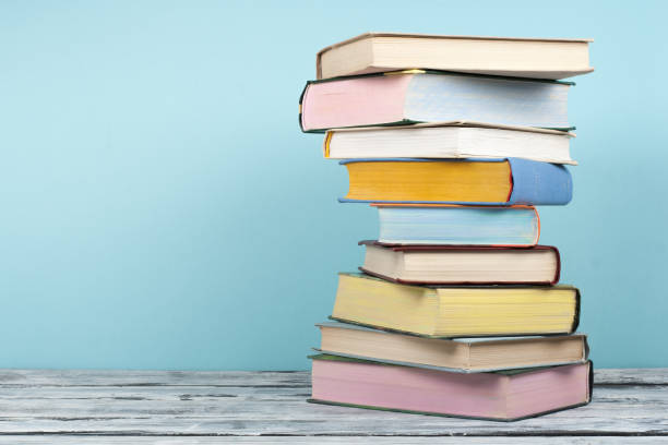 Open book, stacking, hardback books on wooden table and background. Back to school. Copy space for text stock photo