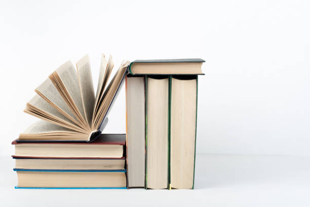 istock Book stack, hardback colorful books on wooden table, white background. Back to school. Copy space for text. Education business concept 689791792