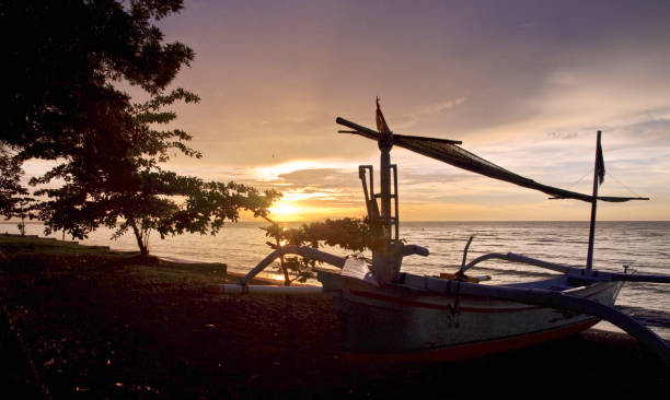 bali. atardecer en la playa de lovina - jukung fotografías e imágenes de stock