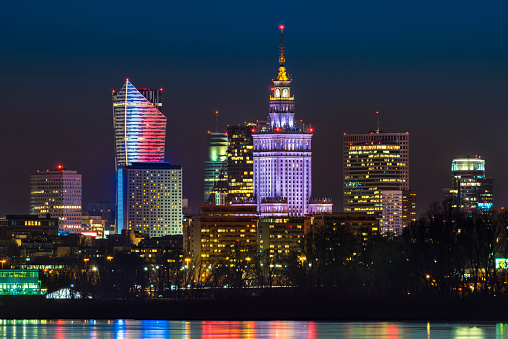 Night panorama of Warsaw skyline over Vistula river, Poland