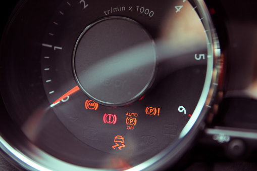 Many different car dashboard lights in closeup