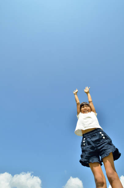 istock Girl bangzaiing in the blue sky 689814764