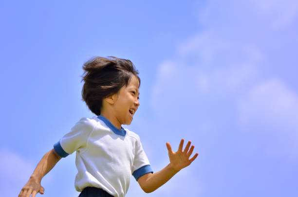Girl running in blue sky (gym clothes)