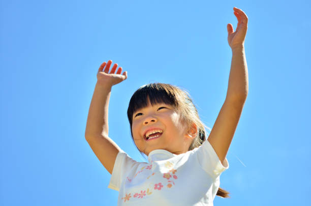 istock Girl bangzaiing in the blue sky 689818058