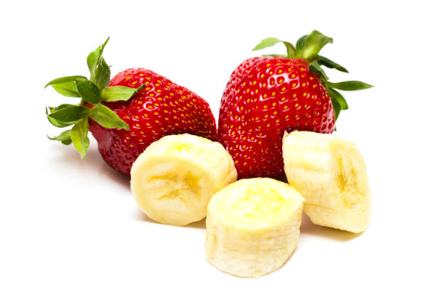 istock Whole strawberry, half and banana pieces 3 isolated on white background as package design element 689818390