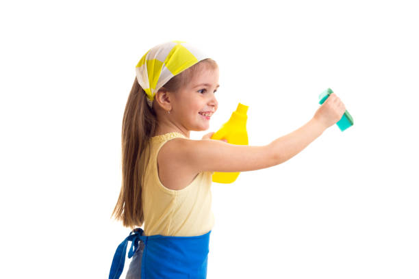 istock Girl in apron with bottle and sponge 689825248