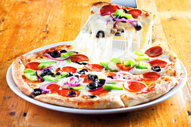 istock Pizza pull with salami, red onion, green peppers and black olives 689825260