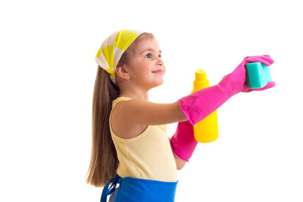 istock Girl in apron with bottle and sponge 689825318