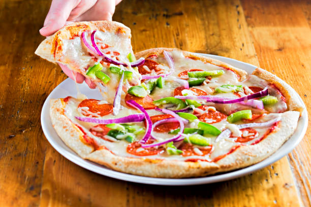 istock Pizza pull with salami, red onion, green peppers and black olives 689825322